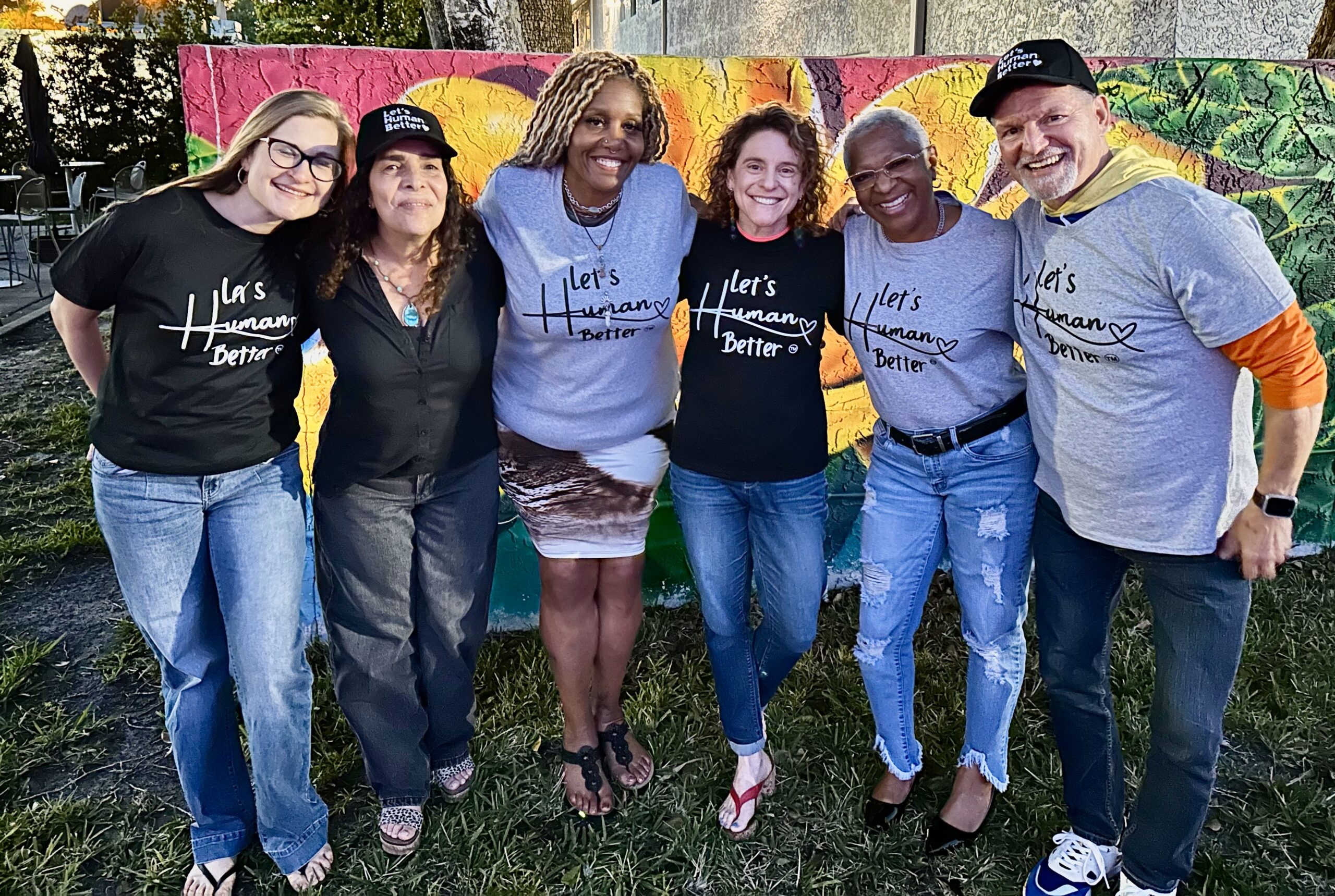 Members of the Dr. Cass Inspires community wearing Let’s Human Better apparel.
